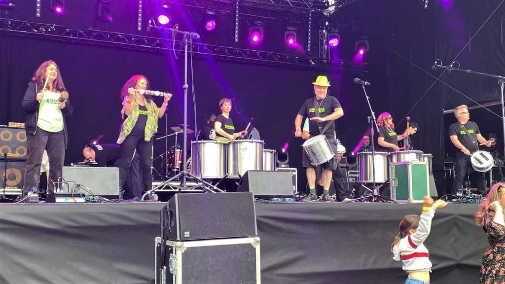Samba drummers on a festival stage.